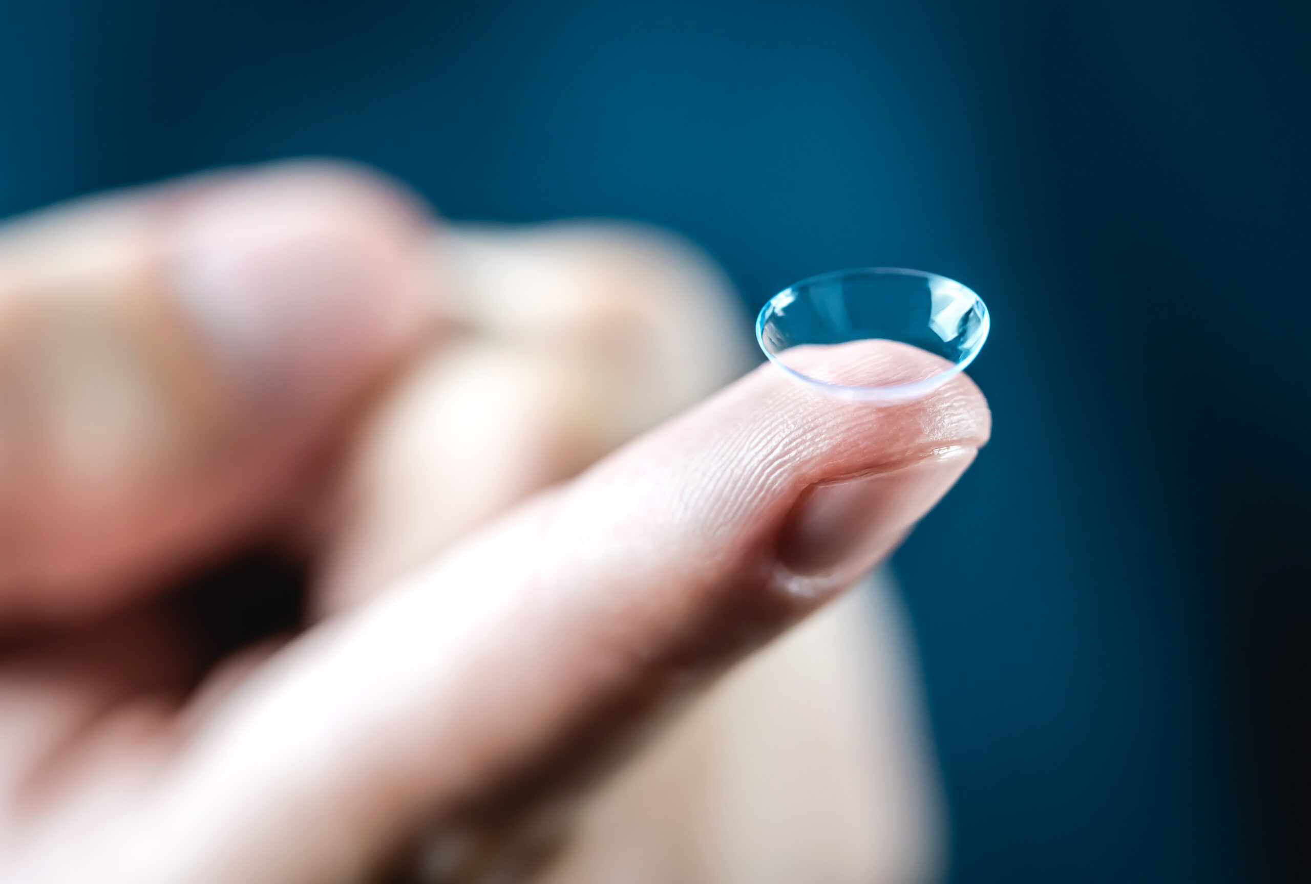 contact-lenses-macro-close-up-man-holding-lens-on-finger-custo